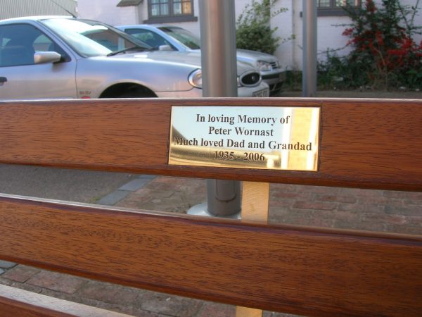 Metal bench with wood slat and plaque