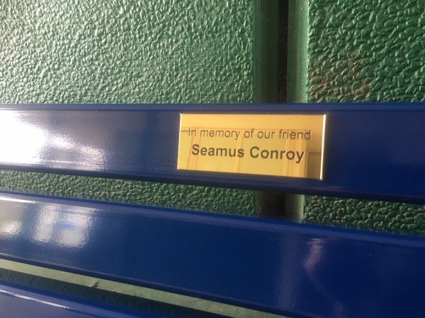 Metal bench with vandal proof slat and sign Bridgford